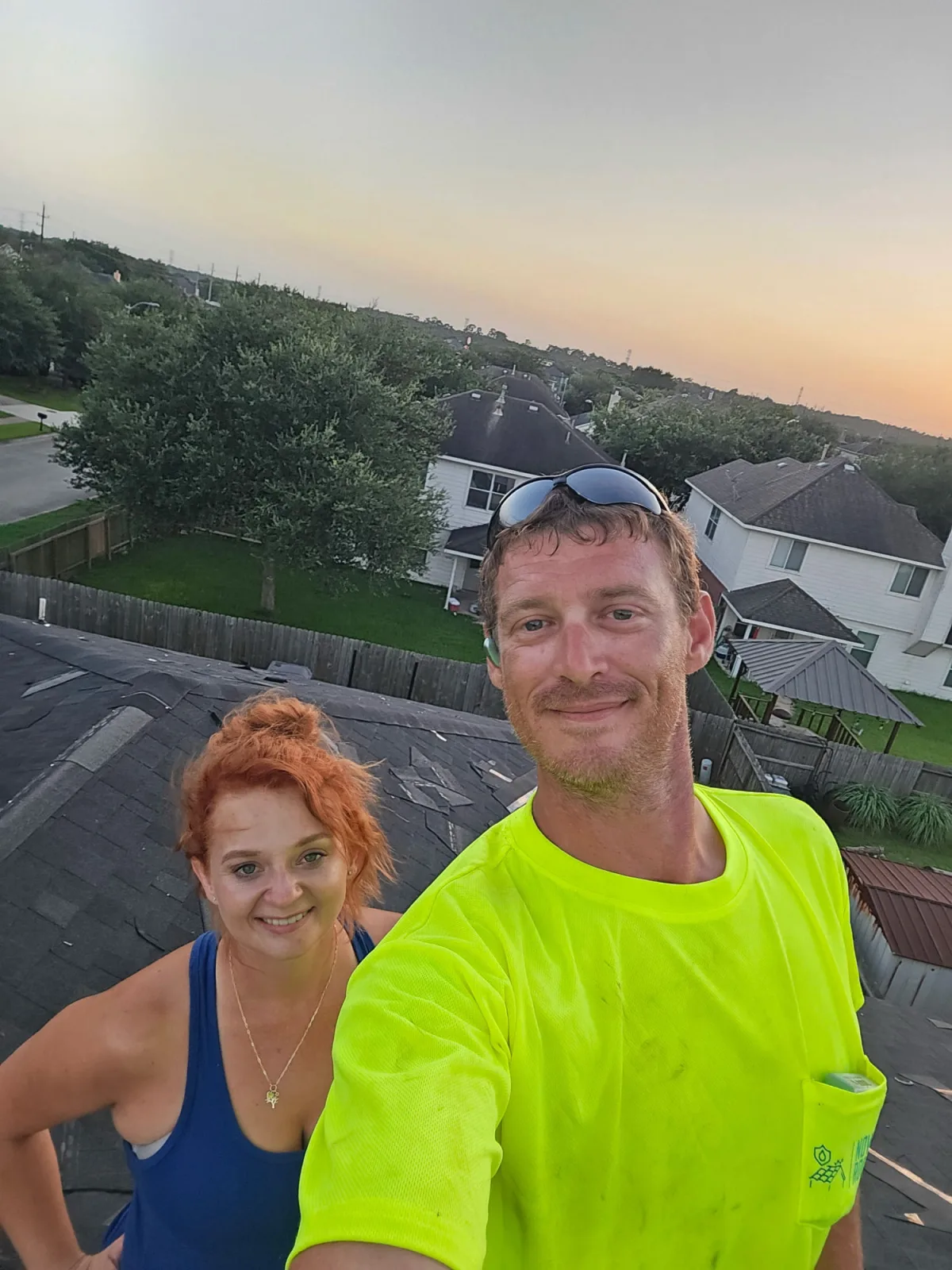 The family-owned Now Roofing team on a Houston-area rooftop at sunset